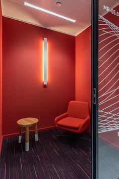 a red room with a chair and table in it