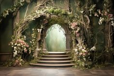 an archway with flowers and greenery on the wall next to steps leading up to it