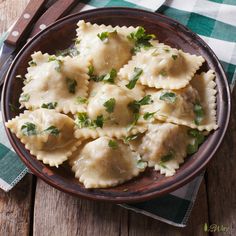 a plate of ravioli with parsley on top