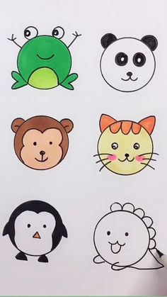 an image of children's animal faces drawn on paper