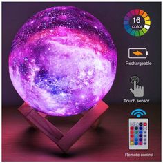 an image of a purple and blue moon lamp on a wooden stand with remote control