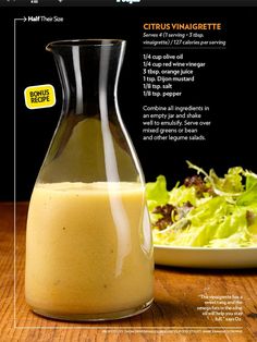 a glass bottle filled with liquid next to a salad