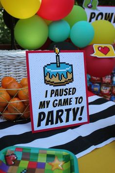 a birthday party with cake and balloons in the background, i raised my game to party