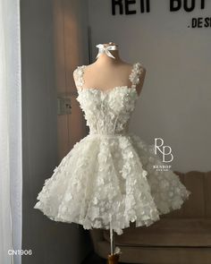 Join us in admiring Renbop's latest mini dress, adorned with beautiful handcrafted embroidered flowers, making the wearer truly stand out with this exquisite beauty ✨ 👰🏻‍♀️  This is undoubtedly the must-have dress for the summer of 2024! 🤍  Dress code: CN1906 Color: Diamond White or Ivory  Renbop Bridal | Luxury Wholesale Supplier ✨ White Formal Dresses Short, Dress For 15, White Luxury Dress, Stand Dress, Cute Short White Dresses, Cute Little White Dress, Mini Gown Dresses, White Short Dress With Flowers, Make Dresses