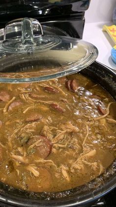 a pan filled with food sitting on top of a stove