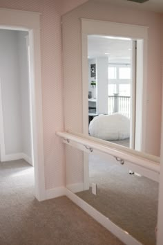 there is a mirror on the wall in this room that has been painted pink and white