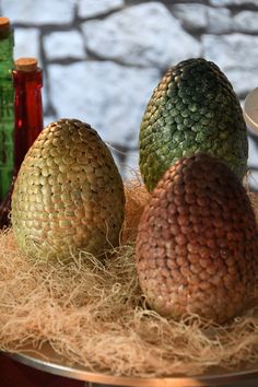 three different types of fruit sitting on top of hay