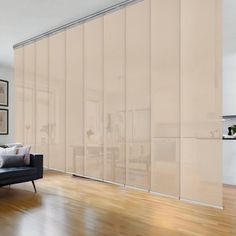 a living room with a couch and sliding glass doors