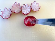 a cutting board with cut up pieces of fruit on it