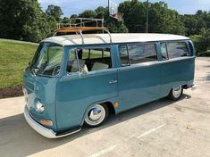 an old vw bus parked in a parking lot