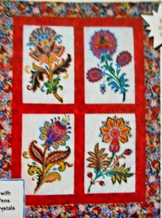 a quilted wall hanging with flowers on it's sides and a sign that says,