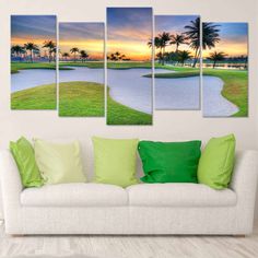 a white couch sitting in front of a wall mounted art print on it's side