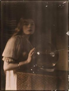 an old photo of a woman holding a bowl