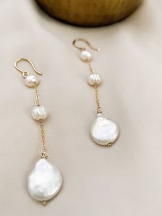 These are perfect for wear every day, with our 3 Pearl dangle earrings you are elegant with them. Is fashionable at any time. If you like simple, classy, and Unique jewelry, these earrings are perfect for you. They make elegant, versatile earrings. Details: - material: 14k gold-filled 14k rose gold-filled sterling silver - measure: 3 inches - Gems: freshwater round pearl and coin pearl (free-form) ADDITIONAL INFORMATION These earrings have been created by hand so no two pieces are identical. Eac Elegant Everyday Hypoallergenic Jewelry, Elegant Handmade Teardrop Linear Earrings, Classic 14k Gold Filled Pearl Drop Jewelry, Elegant 14k Gold Filled Jewelry For Wedding, Handmade Long Drop Elegant Earrings, Handmade Elegant Drop Earrings, Handmade Elegant Long Drop Earrings, Elegant Handmade Drop Earrings, Elegant Silver Pearl Earrings With 14k Gold Filled