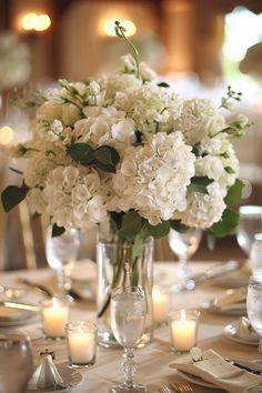 Transform your wedding tables with beautiful hydrangea centerpieces. With simple, DIY designs featuring blue, white, pink, and green hues, these centerpieces provide a fresh, elegant look. Perfect for creating standout blue and white arrangements.Clear chat Wedding Table Decorations Hydrangea Floral Arrangements, Short Hydrangea Centerpiece, White Bouquet Centerpiece, Centerpieces Wedding Hydrangea, Wedding Centerpieces Hydrangea And Roses, Hydrangea And Tulip Centerpiece, Hydrangea And White Roses Centerpiece, White Winter Wedding Flowers Centerpieces, Wedding Wreath Centerpiece