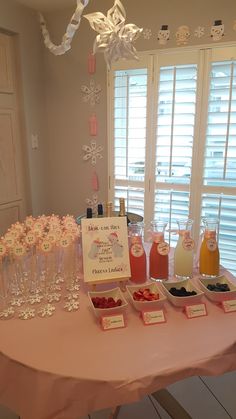 a table topped with lots of desserts and drinks next to a sign that says welcome