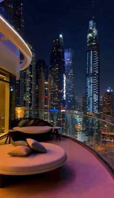 an outdoor lounge area overlooking the city at night