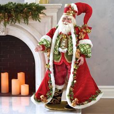 a man dressed as santa claus standing in front of a fireplace