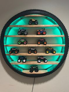 a clock made out of tires and wooden shelves with toy cars on it's sides