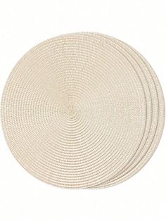 three round placemats in white on a white background with no one around them