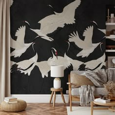 a living room filled with furniture and wallpaper covered in white cranes on black background