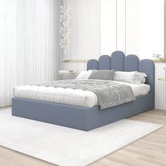 a large bed sitting on top of a wooden floor next to a white rug in a bedroom