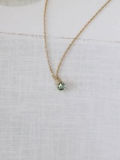 Introducing a sweet little Sapphire necklace in a lovely blue-green hue. Ideal for layering or wearing on its own. Delicate yet mighty, it adds a touch of elegance to any outfit. Handcrafted in our studio from 10K gold. Available in yellow and white gold. 1 x Teal blue/green sapphire (approx 3.5 mm in size). Made entirely of 10K solid gold. 0.85mm signature fine delicate chain. Chain length: 16” (15"+1") | 40cm (37cm +3cm). Green Sapphire Jewelry, Everyday Fine Jewelry Green Necklaces, Green Fine Jewelry Necklace For Everyday, Everyday Fine Jewelry Green Necklace, Dainty 14k Gold Emerald Necklace, Delicate Green Necklace For Everyday Wear, Dainty Emerald Necklace With Round Pendant, 14k Gold Green Birthstone Necklace, Saphire Jewelry