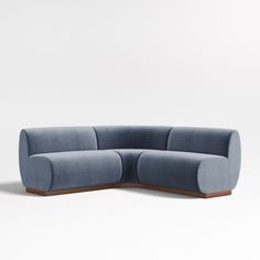 a blue couch sitting on top of a white floor