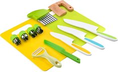 a yellow cutting board with green and white kitchen utensils on top of it