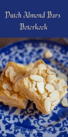 two pieces of almond bars on a blue and white plate with the words dutch almond bars below it