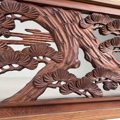 an intricately carved wooden frame with flowers and leaves