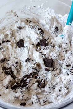 a mixing bowl filled with ice cream and oreo cookie cookies on it's side