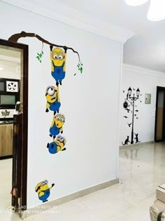 a wall with some cartoon characters on it in a living room next to a kitchen