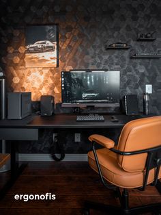 a desk with a computer, keyboard and chair in front of a wallpapered background