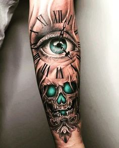 a man's arm with a clock and eye tattoo on it