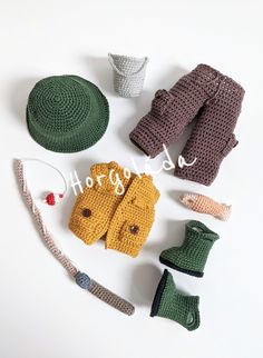 crocheted clothing and accessories laid out on a white surface with the word happy written above them