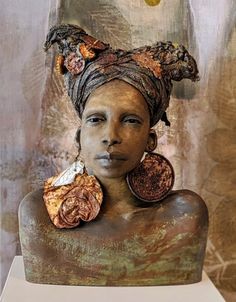 a woman's head is covered in various pieces of art