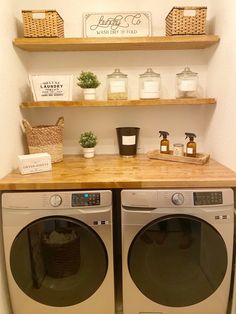 a washer and dryer sitting next to each other on top of a wooden counter