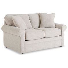 a white couch with two pillows on it's back and the arms folded down