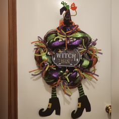 a witch wreath hanging on the front door