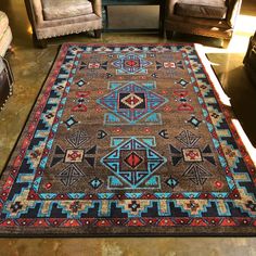 an area rug is shown with two chairs and one chair in the background, along with other furniture