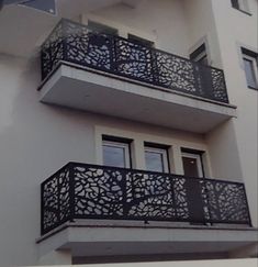 an apartment building with balconies and wrought iron balcony railings