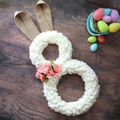 an easter decoration made out of yarn and flowers