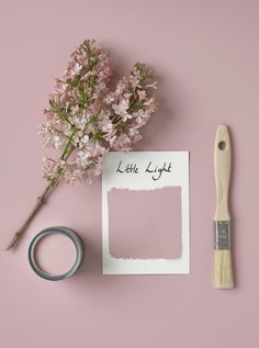 a pink wall with some flowers and a paintbrush on it next to a piece of paper that says little light