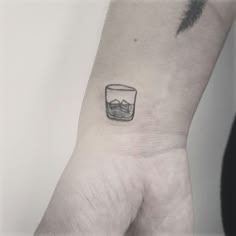 a small glass tattoo on the wrist