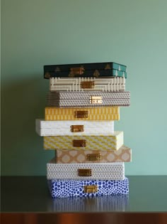 a stack of different colored boxes sitting on top of a table