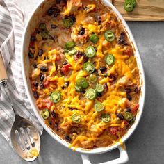 a casserole dish with chicken, black beans, jalapenos and cheese