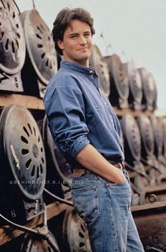 a man standing in front of some old tires