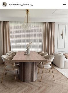 the dining room table is surrounded by beige chairs