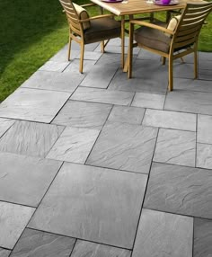 an outdoor table and chairs on a stone patio